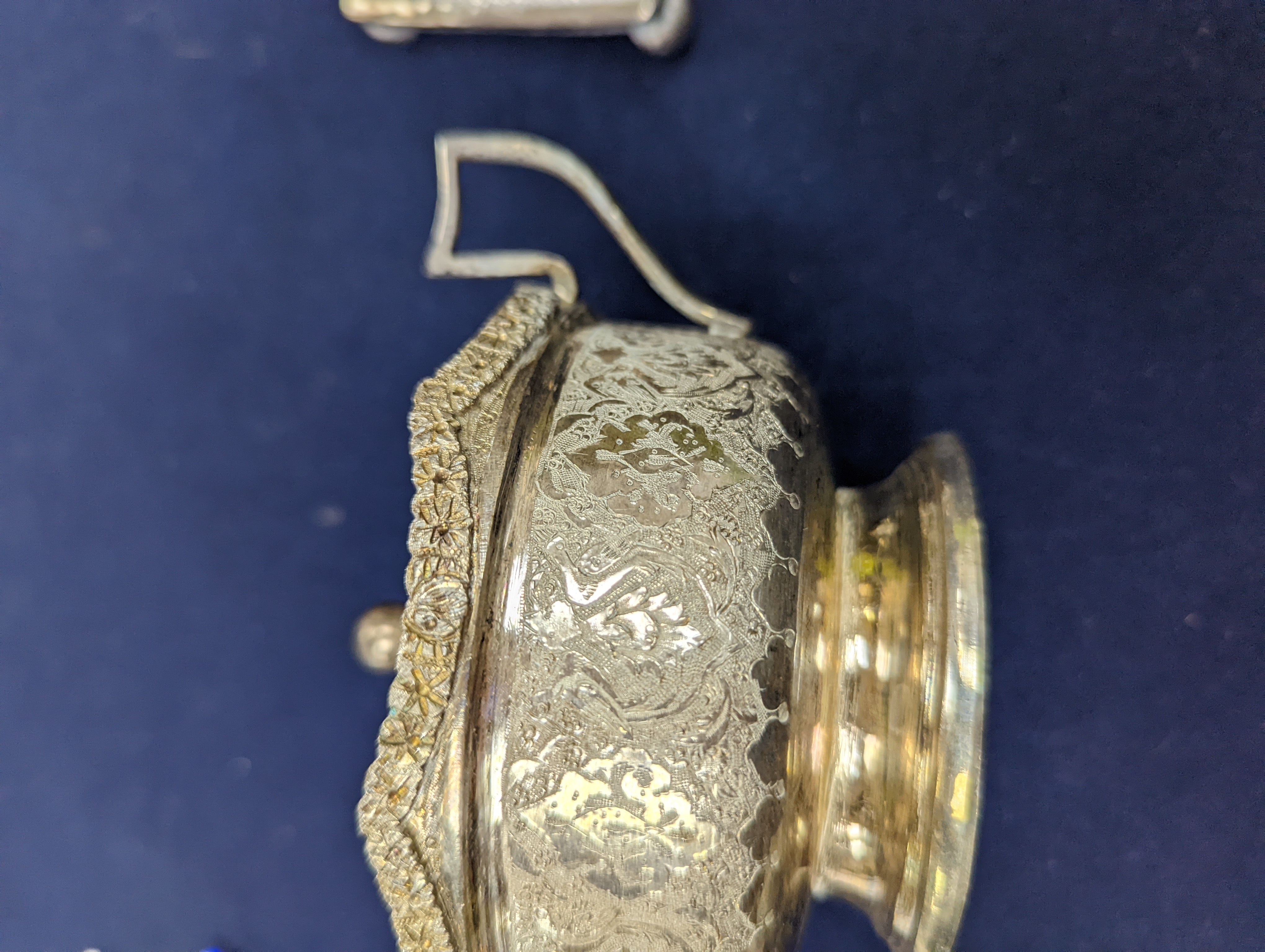 A set of six Persian embossed 84 standard white metal coffee cup holders and matching sugar bowl and cover by Vartan and four other Persian white metal items.